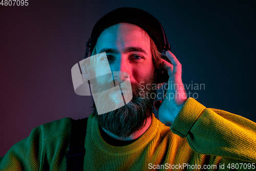 Image of Caucasian man\'s portrait isolated on gradient studio background in neon light