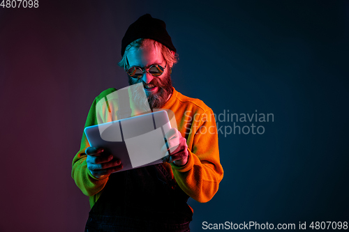 Image of Caucasian man\'s portrait isolated on gradient studio background in neon light