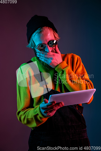 Image of Caucasian man\'s portrait isolated on gradient studio background in neon light