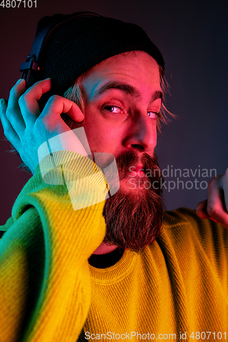 Image of Caucasian man\'s portrait isolated on gradient studio background in neon light