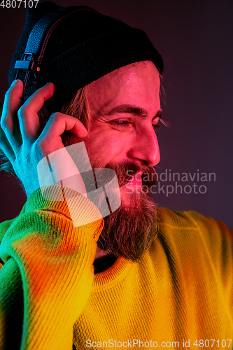 Image of Caucasian man\'s portrait isolated on gradient studio background in neon light