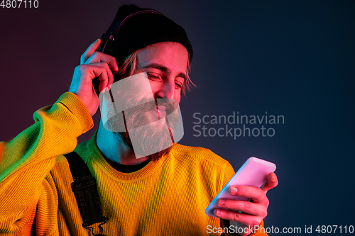 Image of Caucasian man\'s portrait isolated on gradient studio background in neon light