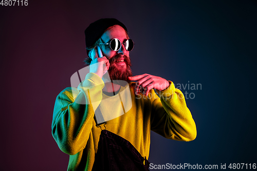 Image of Caucasian man\'s portrait isolated on gradient studio background in neon light