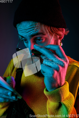 Image of Caucasian man\'s portrait isolated on gradient studio background in neon light