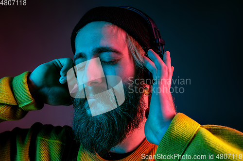 Image of Caucasian man\'s portrait isolated on gradient studio background in neon light