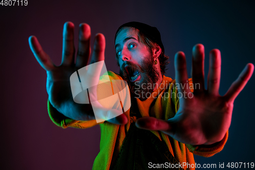 Image of Caucasian man\'s portrait isolated on gradient studio background in neon light