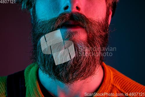 Image of Caucasian man\'s portrait isolated on gradient studio background in neon light