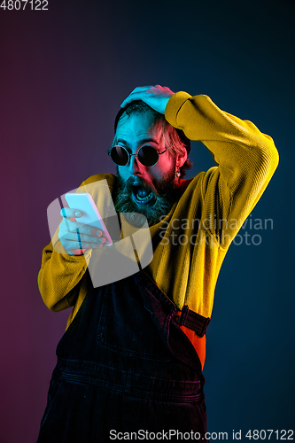 Image of Caucasian man\'s portrait isolated on gradient studio background in neon light