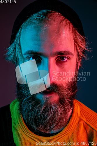 Image of Caucasian man\'s portrait isolated on gradient studio background in neon light