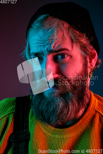 Image of Caucasian man\'s portrait isolated on gradient studio background in neon light