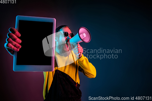 Image of Caucasian man\'s portrait isolated on gradient studio background in neon light