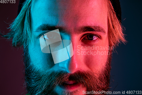Image of Caucasian man\'s portrait isolated on gradient studio background in neon light