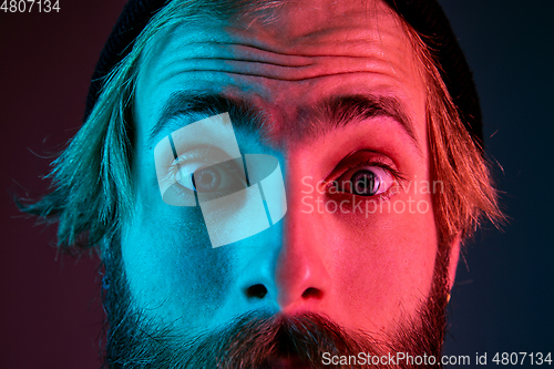 Image of Caucasian man\'s portrait isolated on gradient studio background in neon light