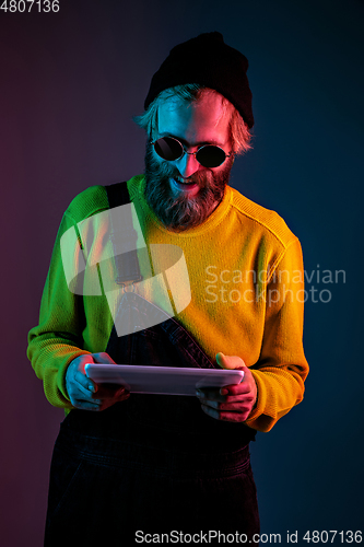 Image of Caucasian man\'s portrait isolated on gradient studio background in neon light
