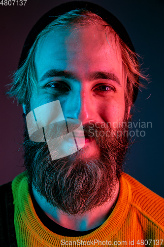 Image of Caucasian man\'s portrait isolated on gradient studio background in neon light