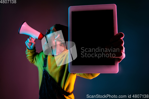 Image of Caucasian man\'s portrait isolated on gradient studio background in neon light