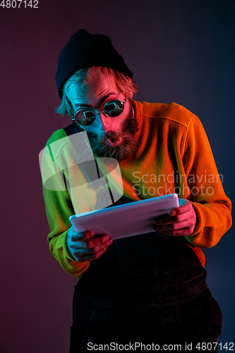 Image of Caucasian man\'s portrait isolated on gradient studio background in neon light