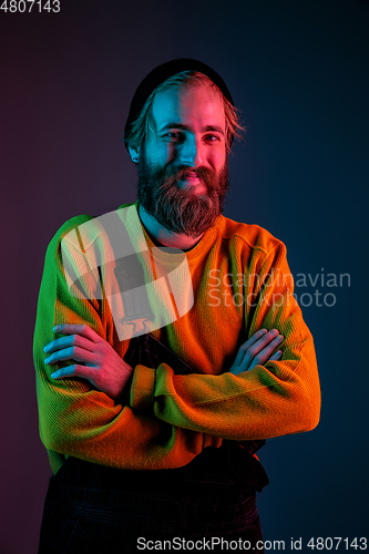 Image of Caucasian man\'s portrait isolated on gradient studio background in neon light