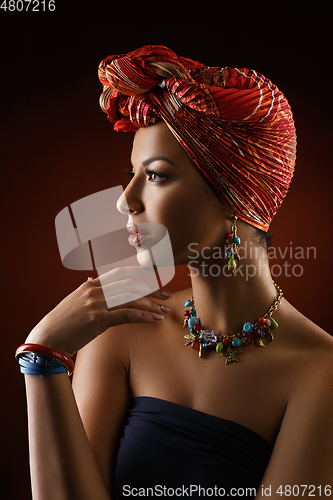 Image of beautiful mulatto young woman with turban on head