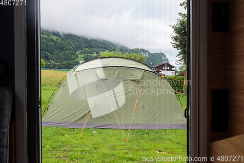 Image of The view from inside the motorhome directly to the tourist tent