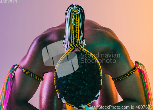 Image of Muay thai. Young man exercising thai boxing on gradient background