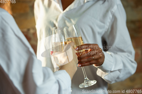 Image of Close up of african-american and caucasian human\'s hands gesturing