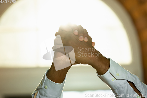 Image of Close up of african-american and caucasian human\'s hands gesturing