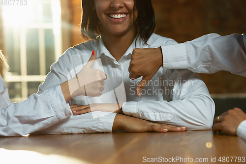 Image of Close up of african-american and caucasian human\'s hands gesturing