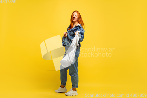 Image of Caucasian woman\'s portrait isolated on yellow studio background, follower be like