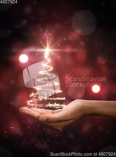 Image of Red Christmas tree in hand