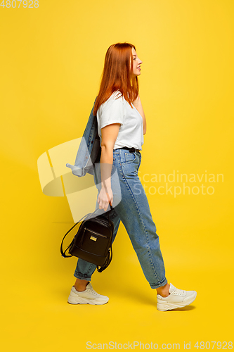 Image of Caucasian woman\'s portrait isolated on yellow studio background, follower be like