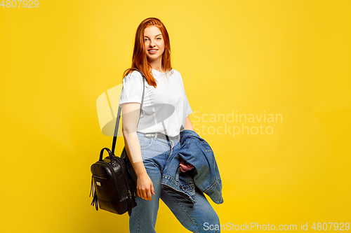 Image of Caucasian woman\'s portrait isolated on yellow studio background, follower be like