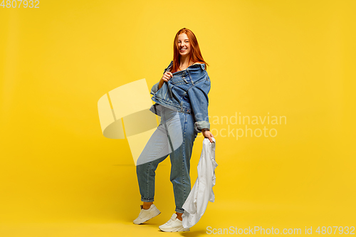 Image of Caucasian woman\'s portrait isolated on yellow studio background, follower be like