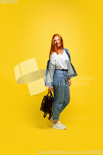 Image of Caucasian woman\'s portrait isolated on yellow studio background, follower be like