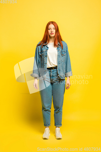 Image of Caucasian woman\'s portrait isolated on yellow studio background, follower be like