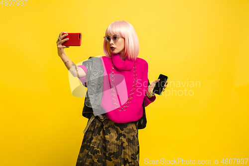 Image of Caucasian woman\'s portrait isolated on yellow studio background, influencer be like