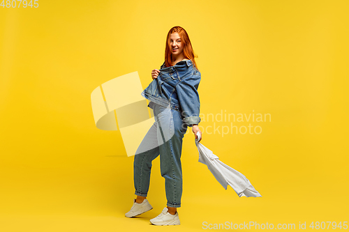 Image of Caucasian woman\'s portrait isolated on yellow studio background, follower be like