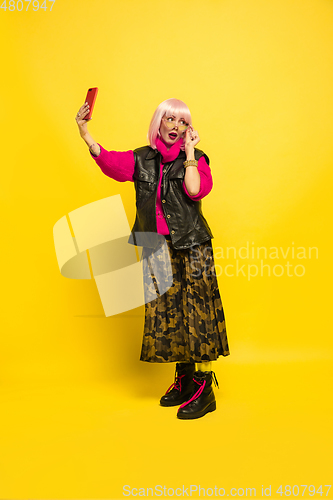Image of Caucasian woman\'s portrait isolated on yellow studio background, influencer be like