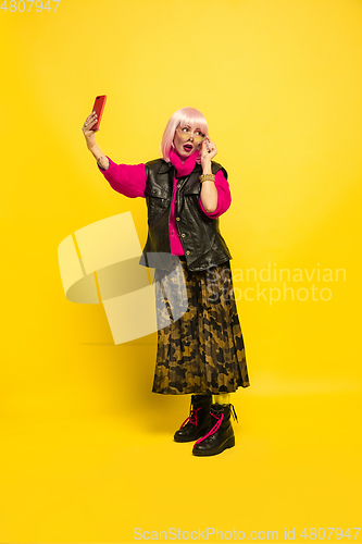 Image of Caucasian woman\'s portrait isolated on yellow studio background, influencer be like