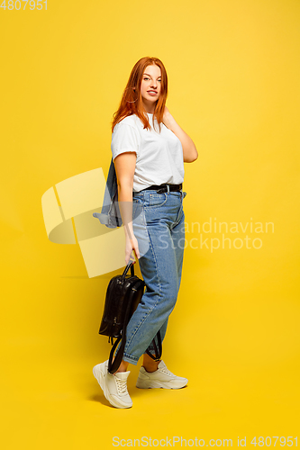 Image of Caucasian woman\'s portrait isolated on yellow studio background, follower be like