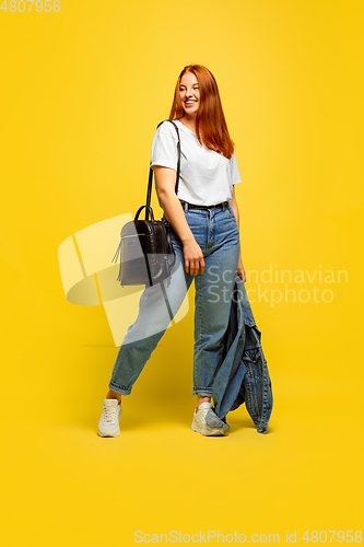 Image of Caucasian woman\'s portrait isolated on yellow studio background, follower be like