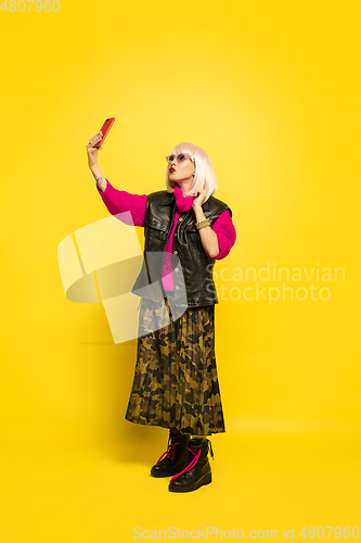 Image of Caucasian woman\'s portrait isolated on yellow studio background, influencer be like