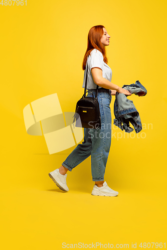 Image of Caucasian woman\'s portrait isolated on yellow studio background, follower be like