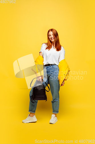 Image of Caucasian woman\'s portrait isolated on yellow studio background, follower be like