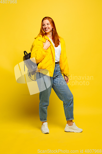 Image of Caucasian woman\'s portrait isolated on yellow studio background, follower be like