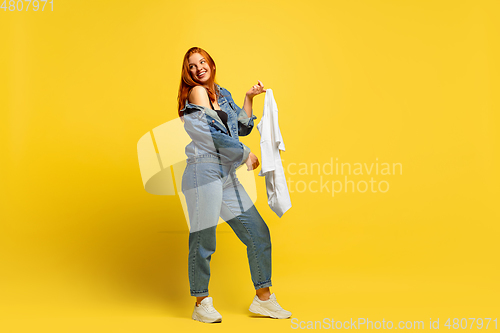 Image of Caucasian woman\'s portrait isolated on yellow studio background, follower be like