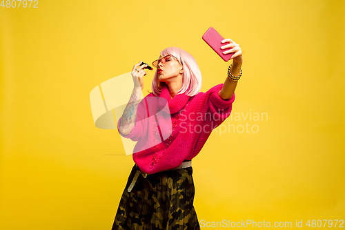 Image of Caucasian woman\'s portrait isolated on yellow studio background, influencer be like