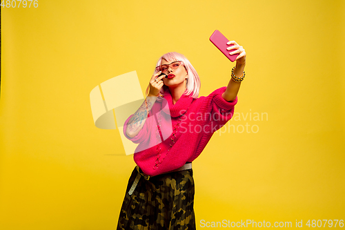 Image of Caucasian woman\'s portrait isolated on yellow studio background, influencer be like