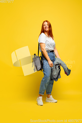 Image of Caucasian woman\'s portrait isolated on yellow studio background, follower be like