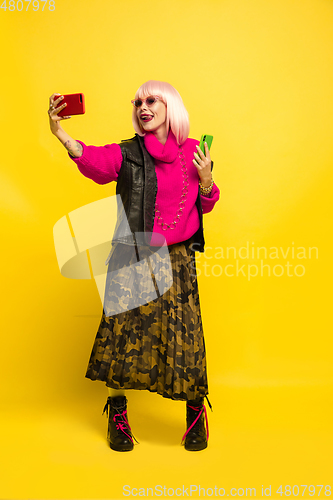 Image of Caucasian woman\'s portrait isolated on yellow studio background, influencer be like